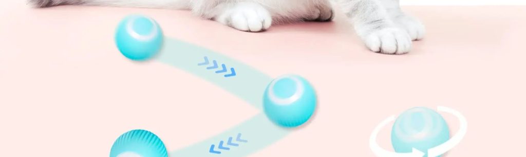 A cat is playing with a blue ball that has a white curved line on it. The cat is white and gray and the background is mostly white.